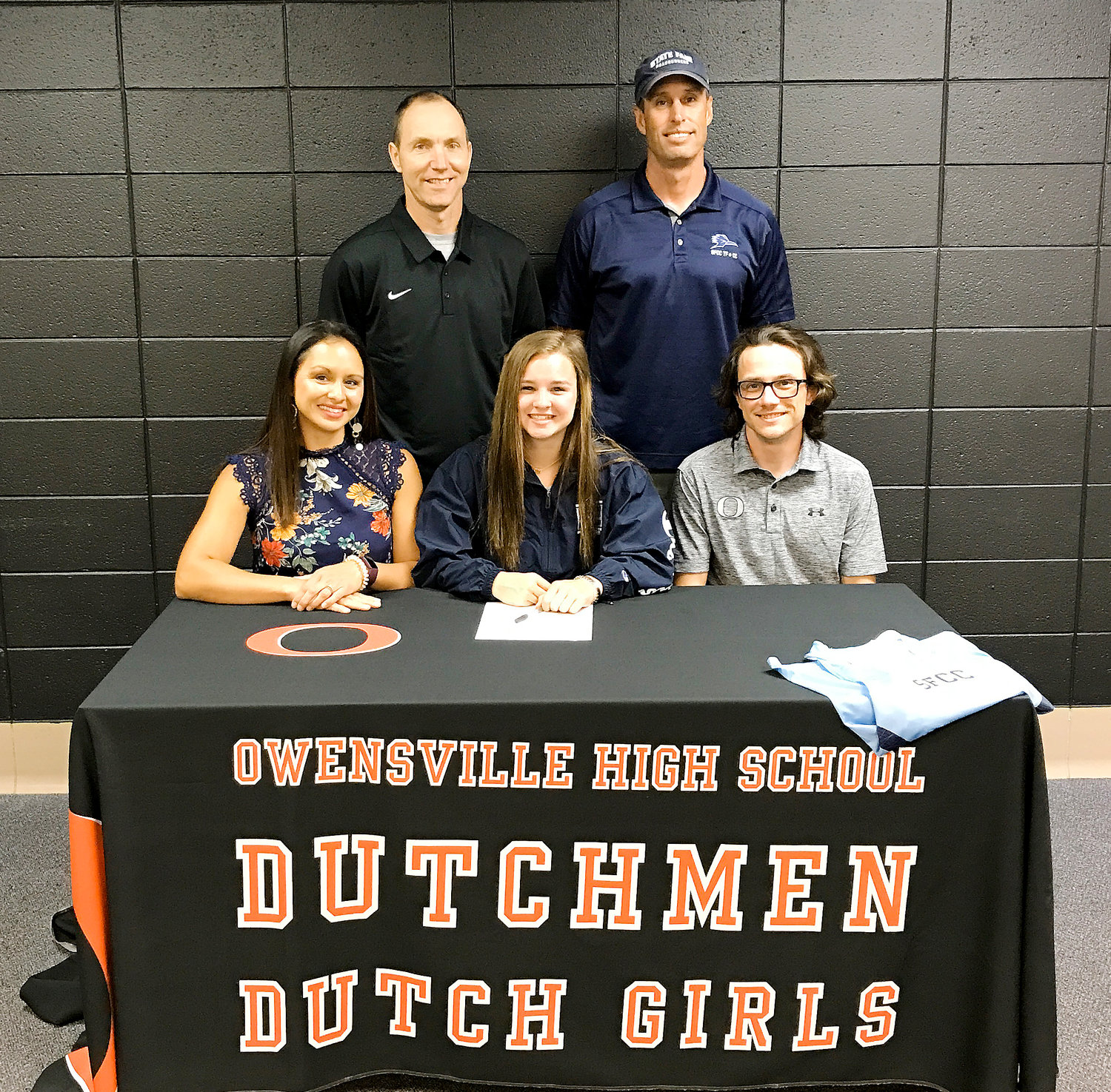 Kohrmann (seated in center) signs her letter of intent to continue her athletic and academic pursuits as a member of the State Fair Community College Roadrunners Track and Field team.